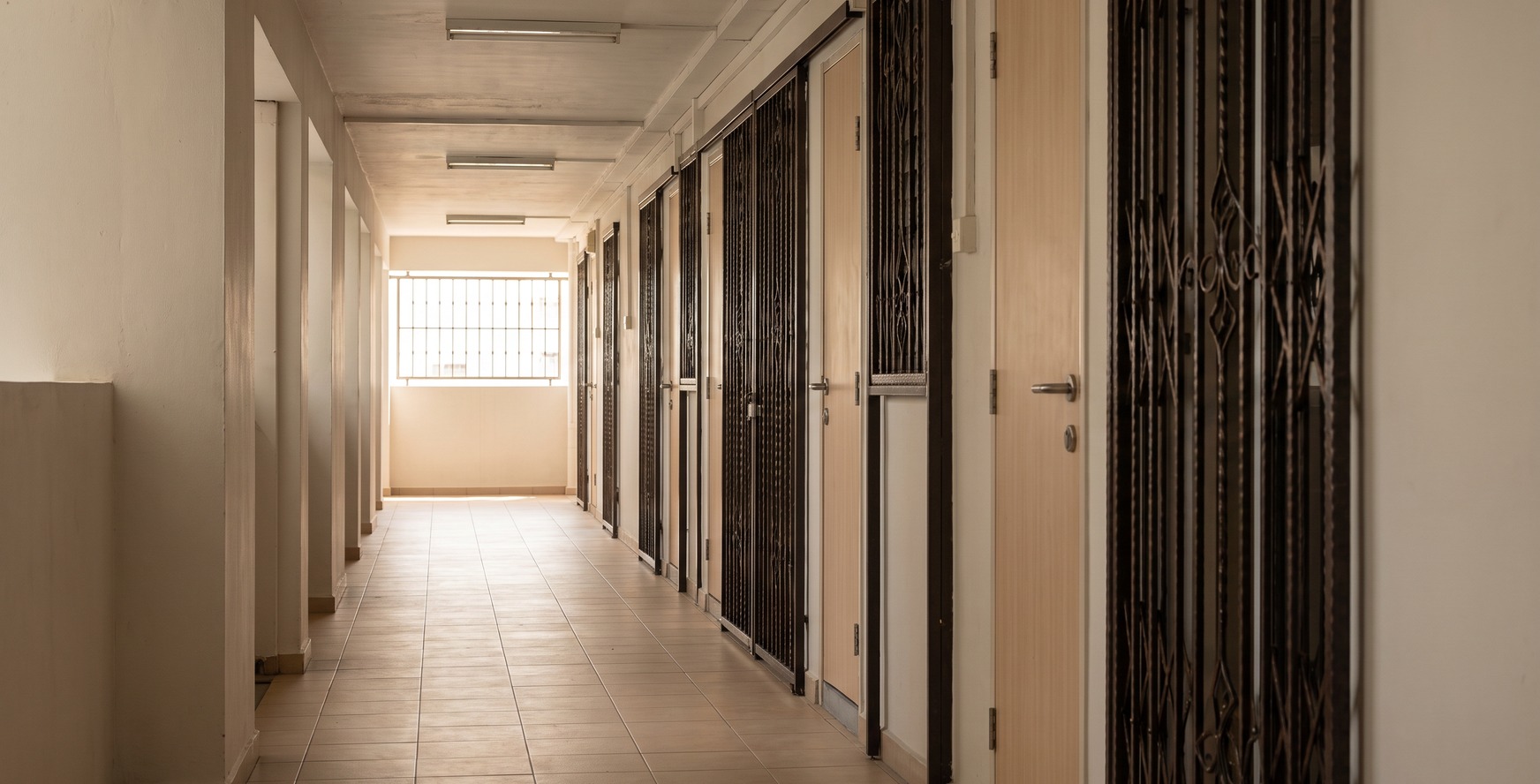 View down an HDB corridor with numbered unit doors